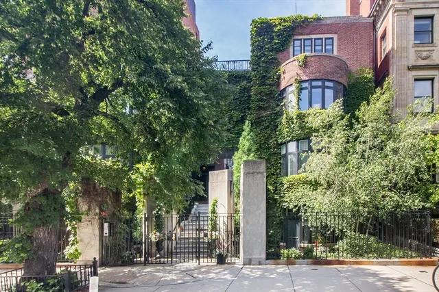 a front view of a building with trees