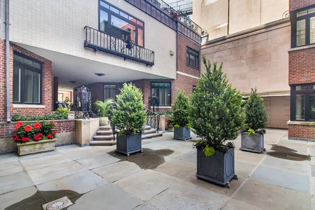 a view of a building with potted plants