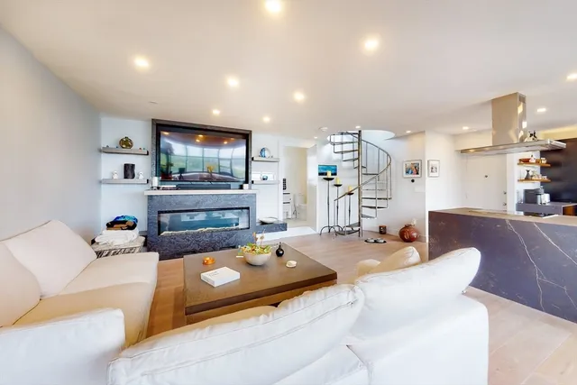 a living room with fireplace furniture and a flat screen tv