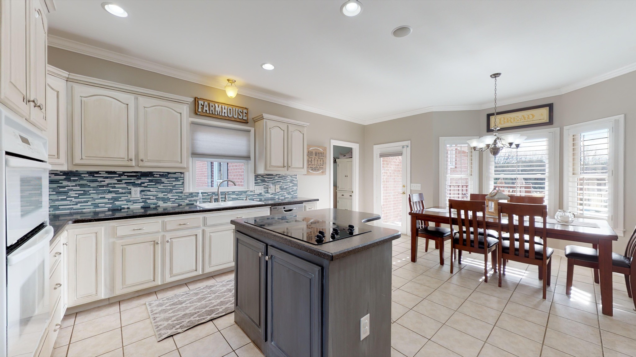 7450 Delbridge Road Murfreesboro, TN 37127 - Photo 16 of 50 a kitchen with granite countertop sink table and chairs