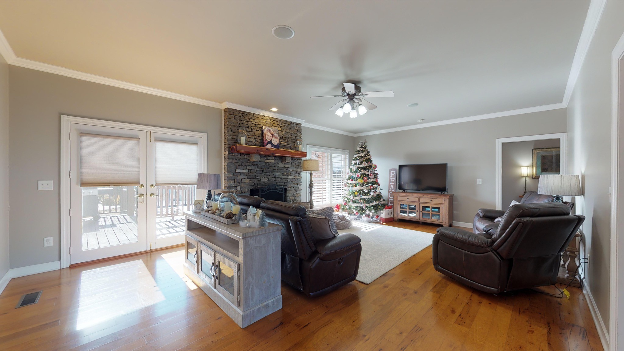 7450 Delbridge Road Murfreesboro, TN 37127 - Photo 19 of 50 a living room with furniture a flat screen tv and a fireplace