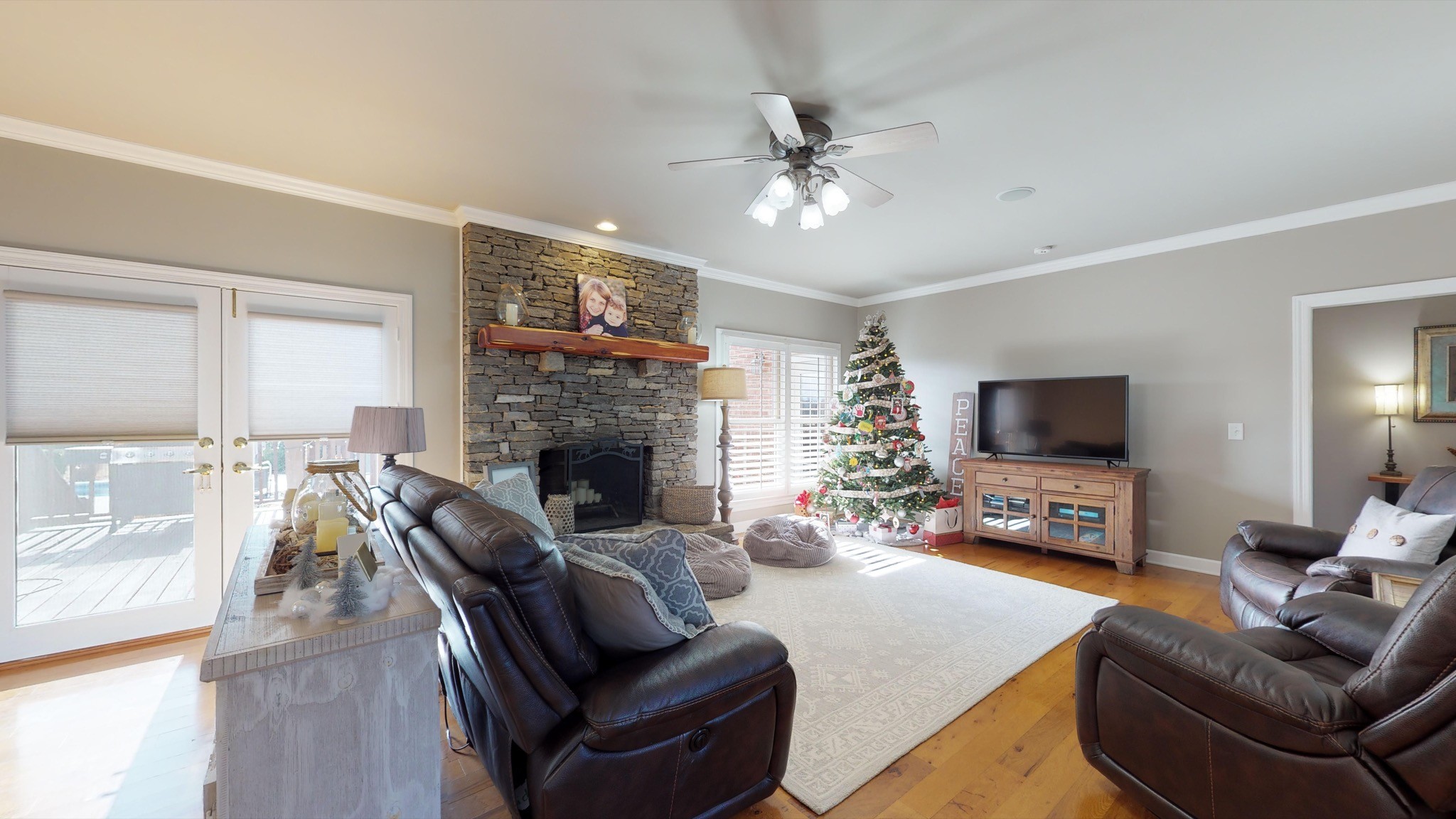 7450 Delbridge Road Murfreesboro, TN 37127 - Photo 20 of 50 a living room with furniture a flat screen tv and a fireplace