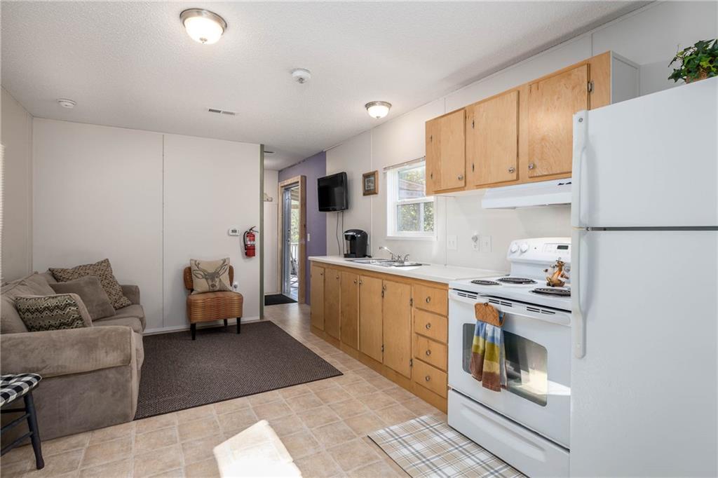 476 Hewitt Run Wind Ridge, PA 15380 - Photo 7 of 28 a kitchen with a refrigerator and white cabinets