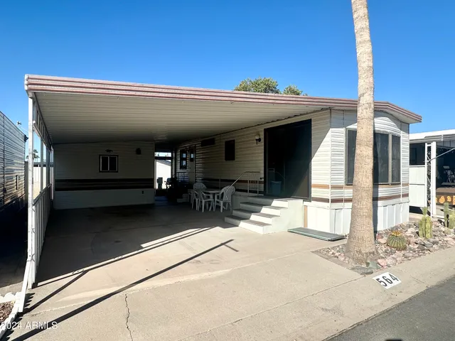 a view of a hallway with a computer on a table and chairs