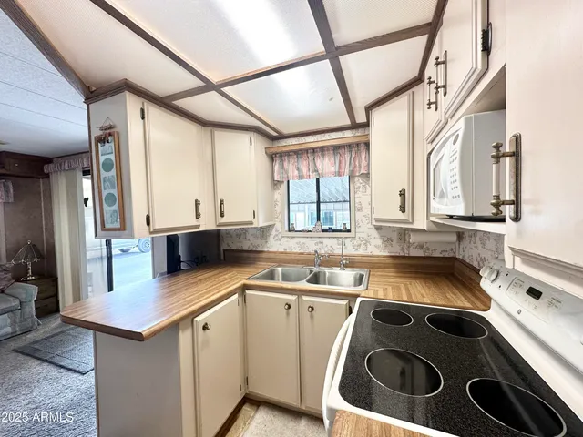 a kitchen with stainless steel appliances granite countertop a sink and a cabinets