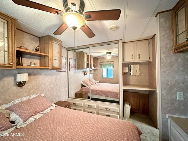 a spacious bedroom with a bed and a chandelier