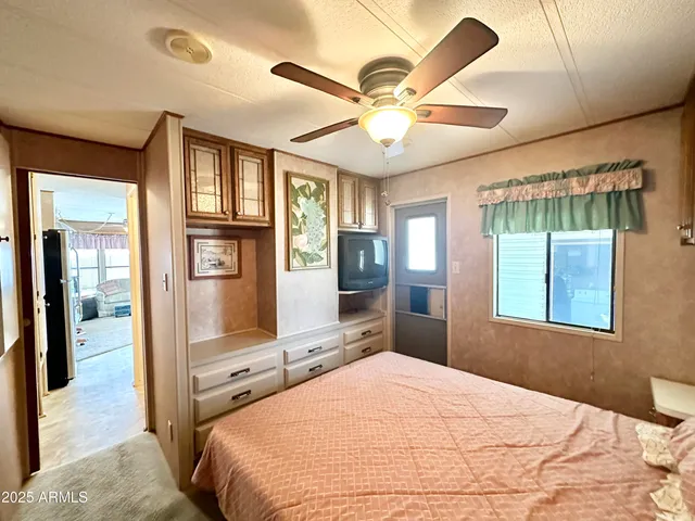 a bedroom with a bed and a chandelier