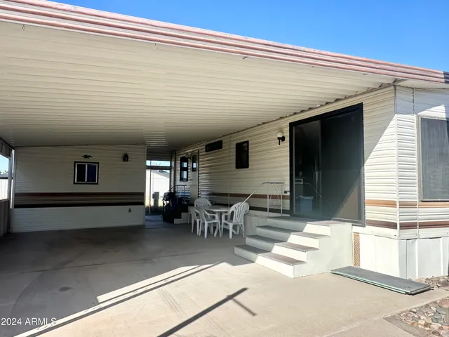a view of a patio with table and chairs with wooden floor
