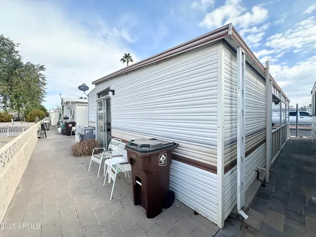 a view of a patio with table and chairs with wooden floor and fence
