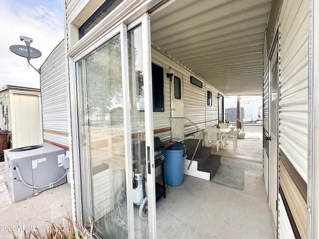 a view of a patio with table and chairs with wooden fence and plants