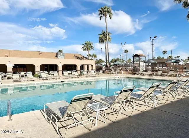 a view of swimming pool with outdoor seating