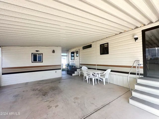 a view of a chairs and table in the back yard