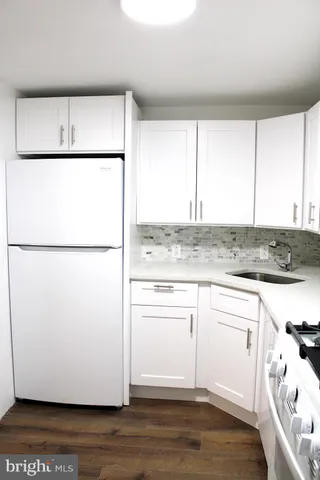 a white refrigerator freezer sitting inside of a kitchen