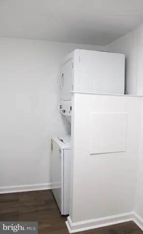 a view of a small space with wooden floor and a window