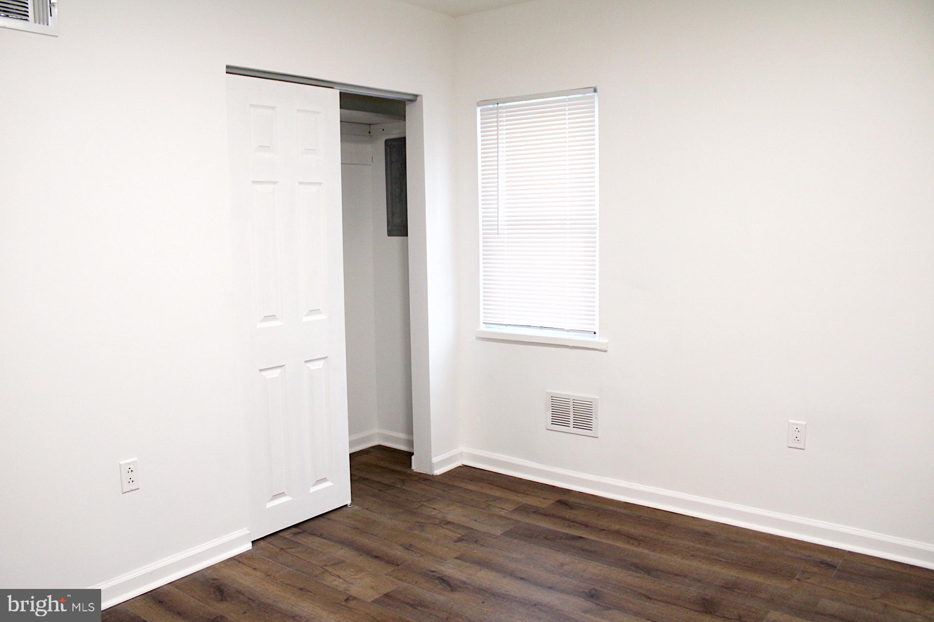 1128 West Browning Road, Unit 1 Bellmawr, NJ 08031 - Photo 15 of 19 a view of an empty room with wooden floor and a window