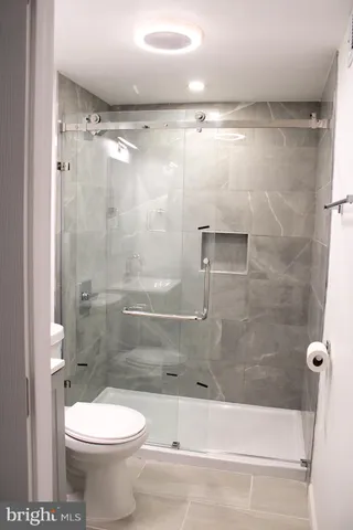 a bathroom with a sink a toilet and mirror