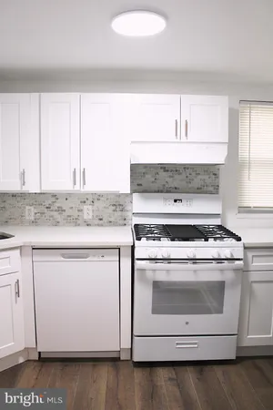 a stove top oven sitting inside of a kitchen