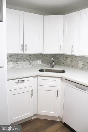 a kitchen with cabinets appliances and a counter top