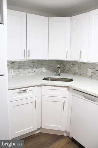 a kitchen with cabinets appliances and a counter top
