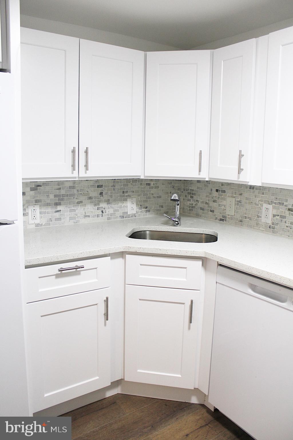 1128 West Browning Road, Unit 1 Bellmawr, NJ 08031 - Photo 8 of 19 a kitchen with cabinets appliances and a counter top