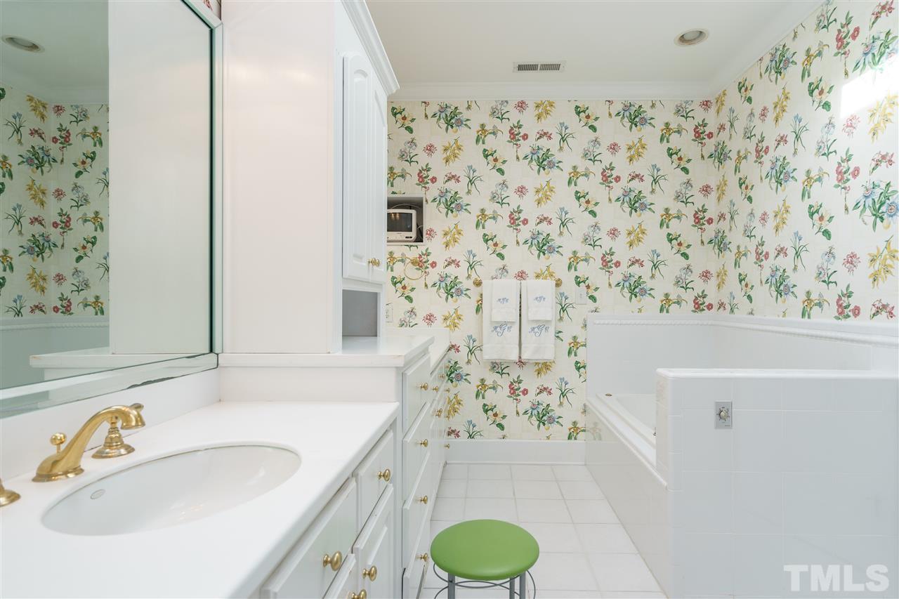 1621 St Marys Street Raleigh, NC 27608 - Photo 17 of 25 a bathroom with a sink and a mirror