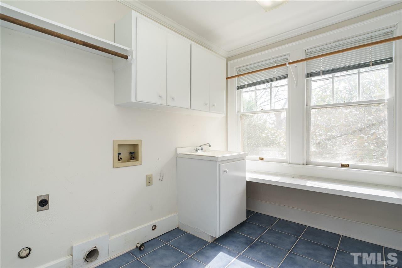 1621 St Marys Street Raleigh, NC 27608 - Photo 20 of 25 a kitchen with a white cabinets and a window