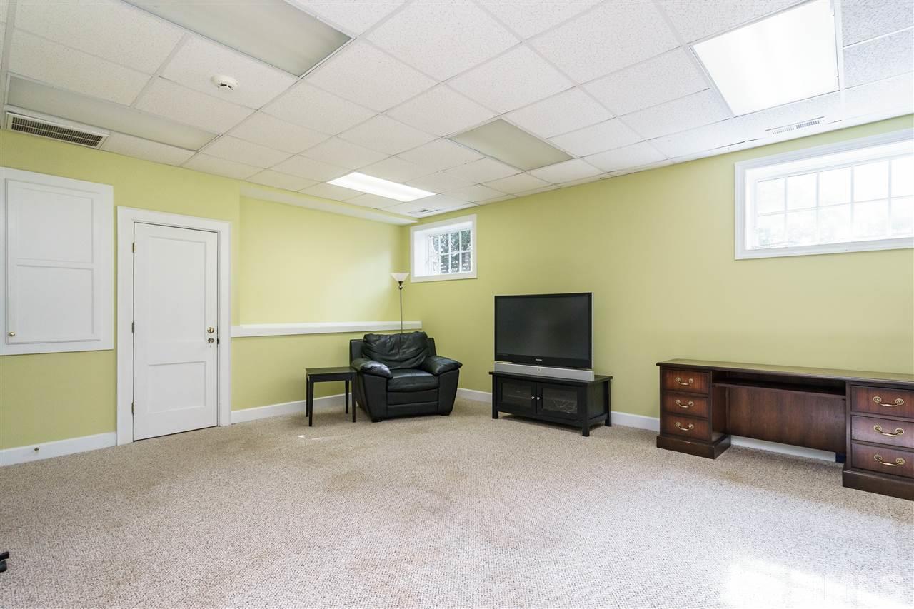 1621 St Marys Street Raleigh, NC 27608 - Photo 21 of 25 a living room with furniture and a flat screen tv