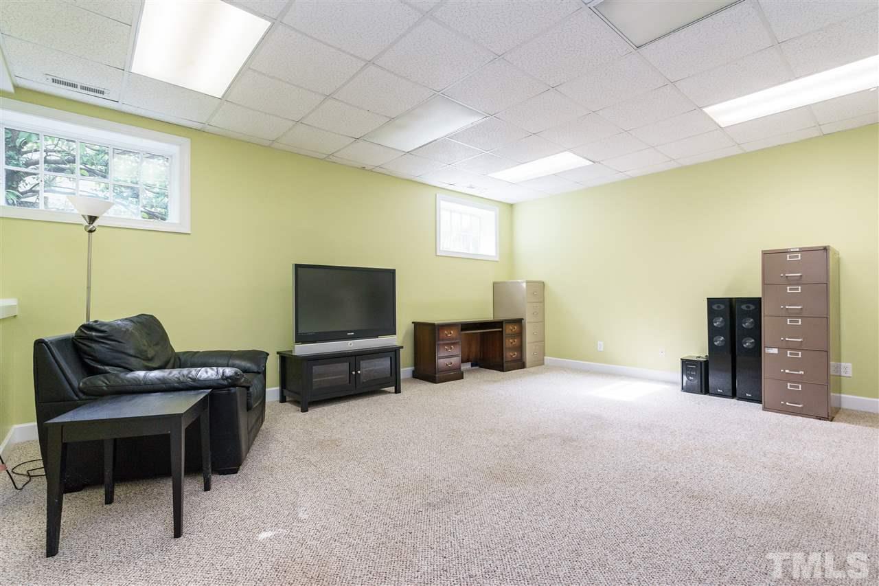 1621 St Marys Street Raleigh, NC 27608 - Photo 22 of 25 a living room with furniture and a flat screen tv