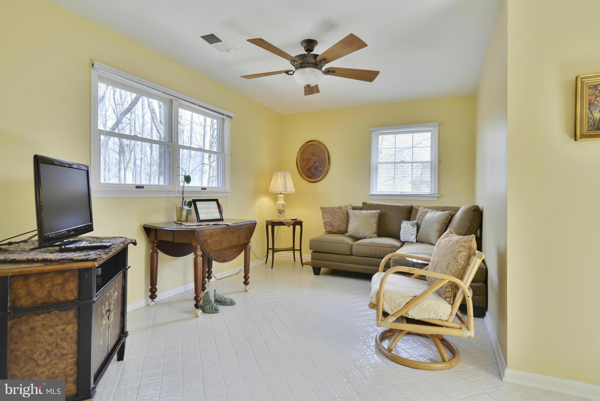 9 Redgate Court Silver Spring, MD 20905 - Photo 10 of 29 a living room with furniture a fireplace and a flat screen tv