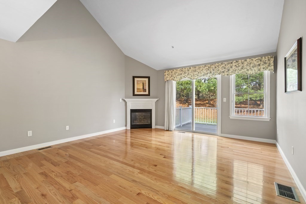 4 Strawberry Lane, Unit E Hudson, MA 01749 - Photo 14 of 40 wooden floor fireplace and windows in an empty room