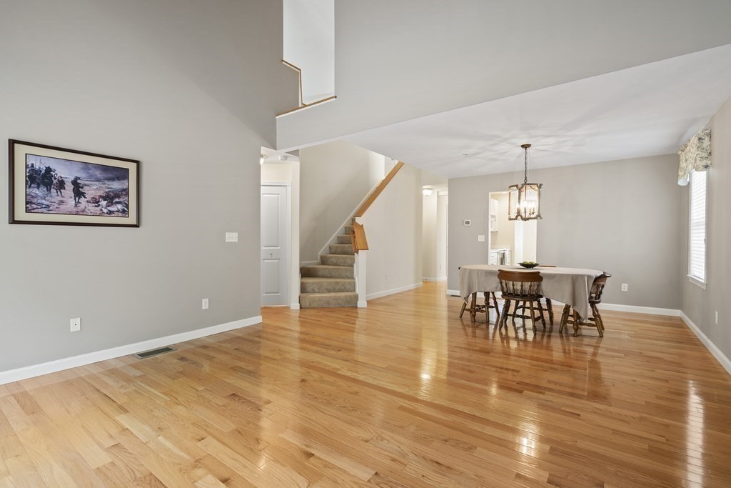 4 Strawberry Lane, Unit E Hudson, MA 01749 - Photo 16 of 40 a view of a dining room with furniture and wooden floor
