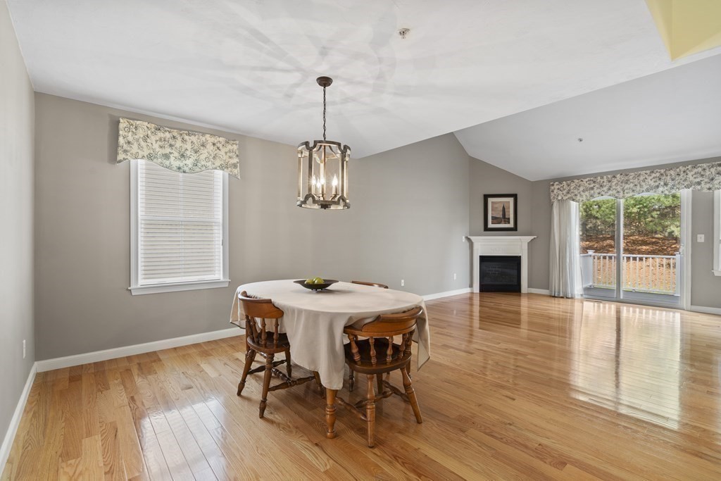4 Strawberry Lane, Unit E Hudson, MA 01749 - Photo 17 of 40 a view of a dining room with furniture window and wooden floor