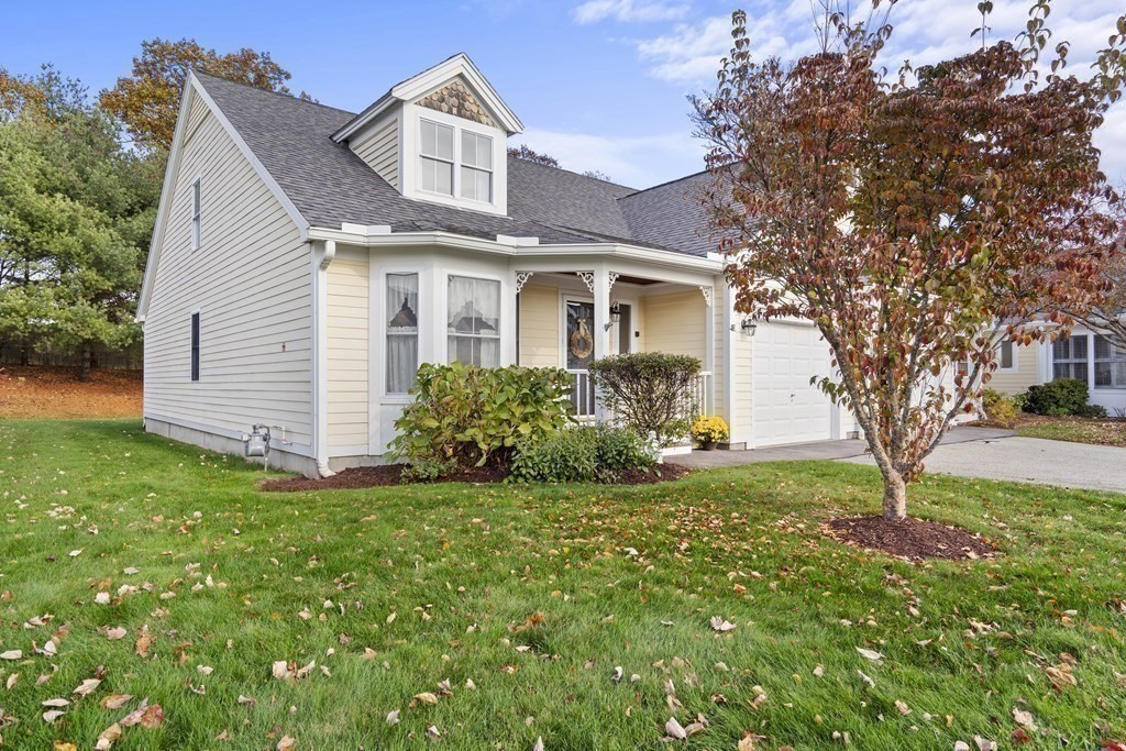 4 Strawberry Lane, Unit E Hudson, MA 01749 - Photo 18 of 40 a front view of a house with a yard