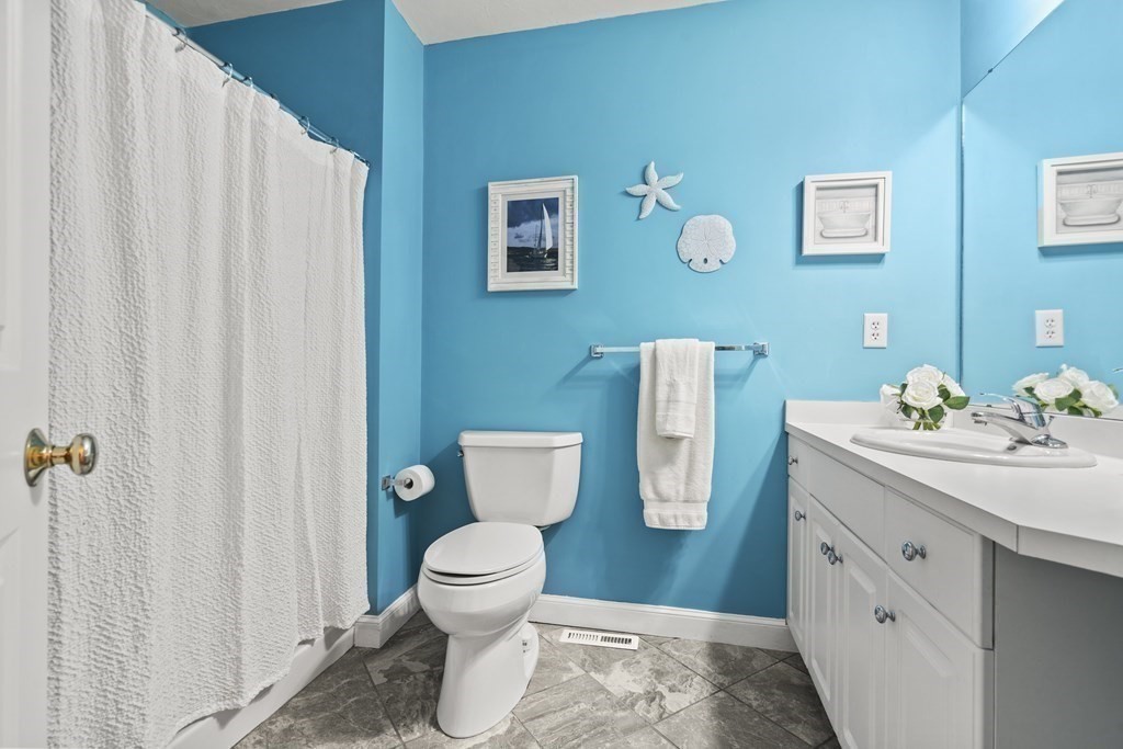 4 Strawberry Lane, Unit E Hudson, MA 01749 - Photo 21 of 40 a white toilet sitting next to a bathroom sink