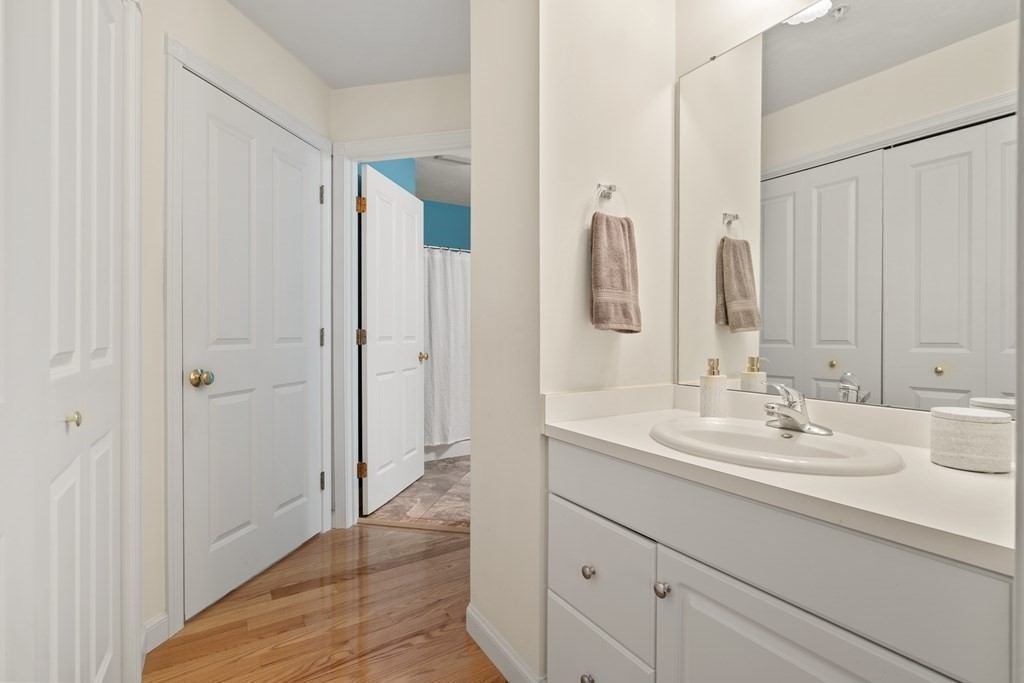 4 Strawberry Lane, Unit E Hudson, MA 01749 - Photo 22 of 40 a bathroom with a sink and a mirror