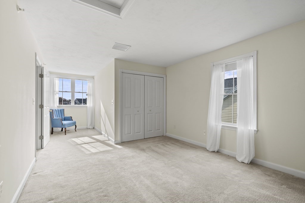 4 Strawberry Lane, Unit E Hudson, MA 01749 - Photo 25 of 40 a view of an empty room with a window