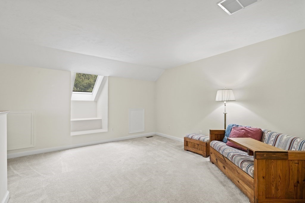 4 Strawberry Lane, Unit E Hudson, MA 01749 - Photo 27 of 40 a living room with furniture and a window