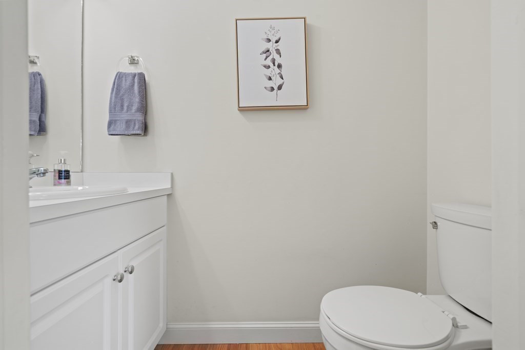 4 Strawberry Lane, Unit E Hudson, MA 01749 - Photo 30 of 40 a bathroom with a toilet sink and vanity