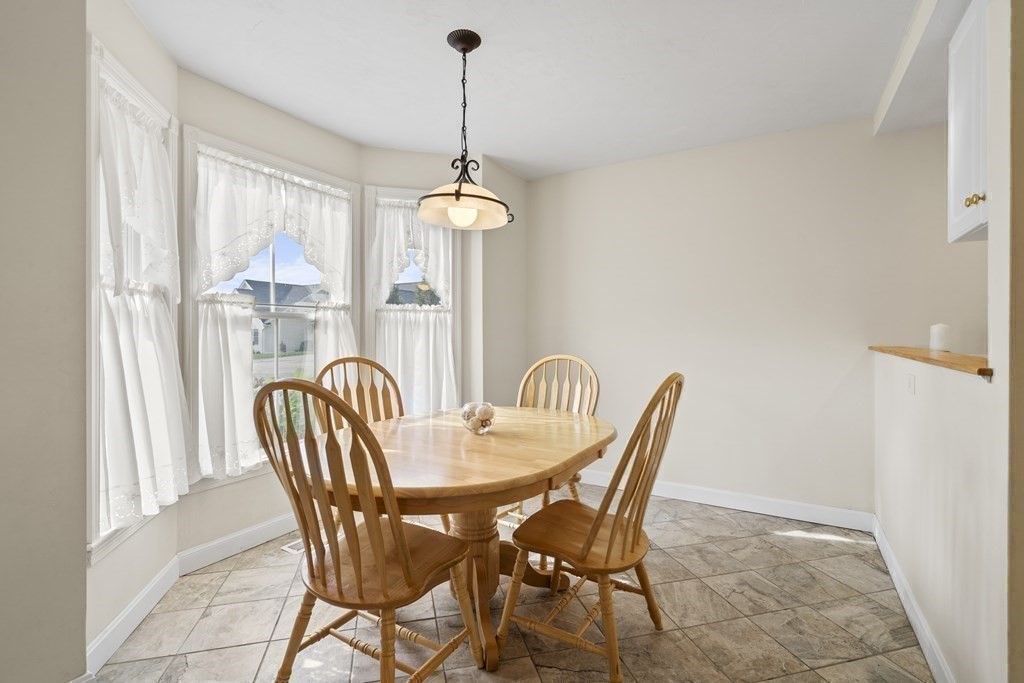 4 Strawberry Lane, Unit E Hudson, MA 01749 - Photo 3 of 40 a view of a dining room with furniture window and outside view
