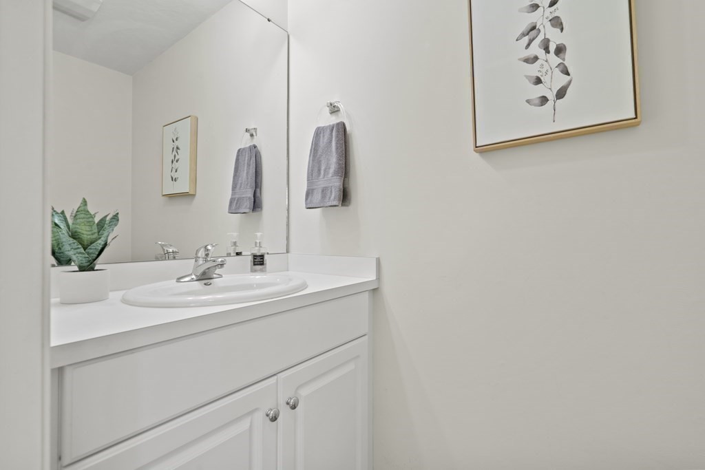 4 Strawberry Lane, Unit E Hudson, MA 01749 - Photo 31 of 40 a bathroom with a sink and a mirror