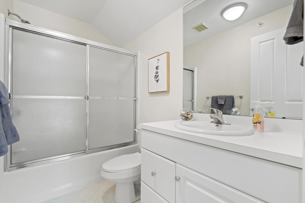 4 Strawberry Lane, Unit E Hudson, MA 01749 - Photo 32 of 40 a bathroom with a sink a toilet and shower