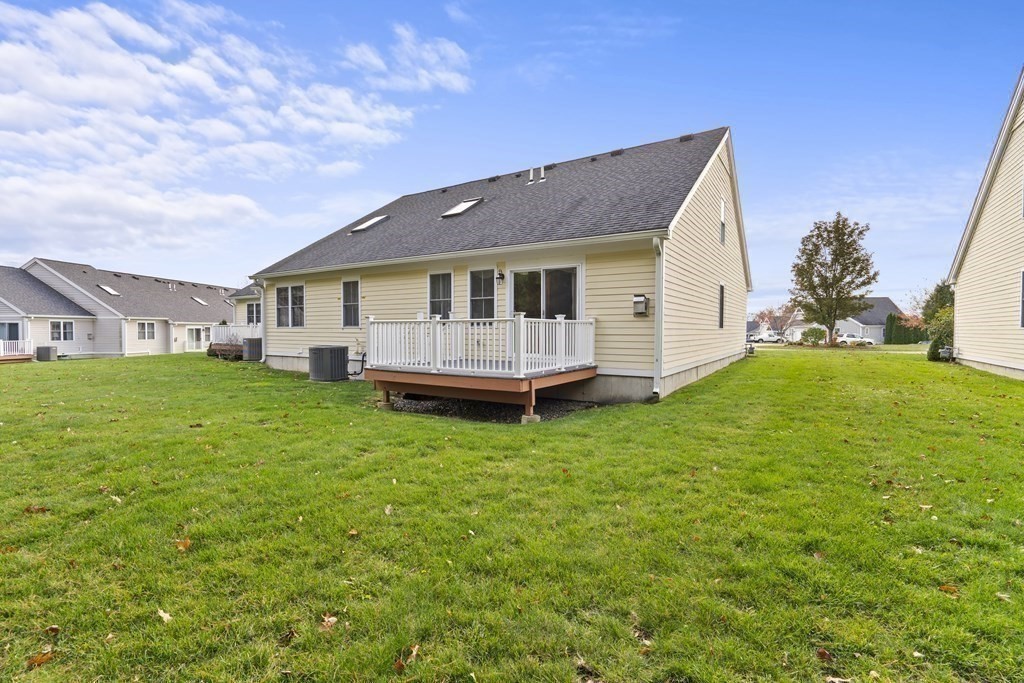 4 Strawberry Lane, Unit E Hudson, MA 01749 - Photo 35 of 40 a view of a house with a yard and sitting area
