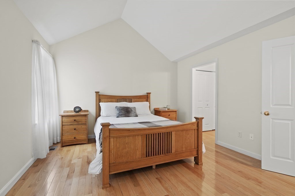 4 Strawberry Lane, Unit E Hudson, MA 01749 - Photo 10 of 40 a bedroom with a bed and wooden floor