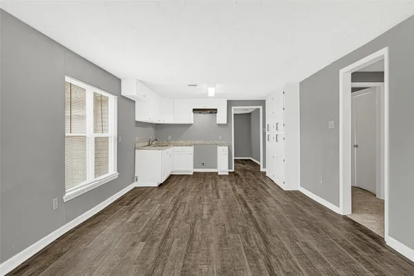 a view of a livingroom with wooden floor and a window