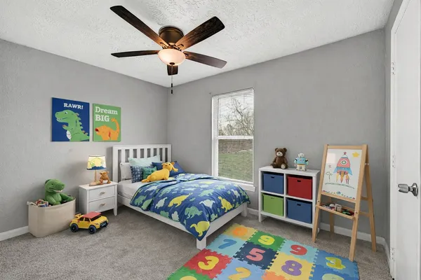 a bedroom with a bed and a chandelier
