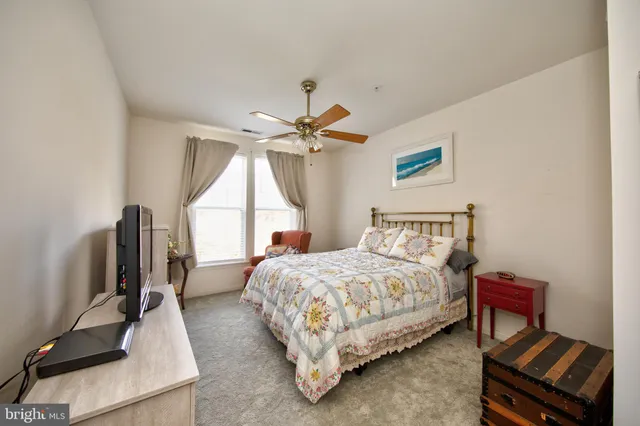 a bed room with a bed window and a chair