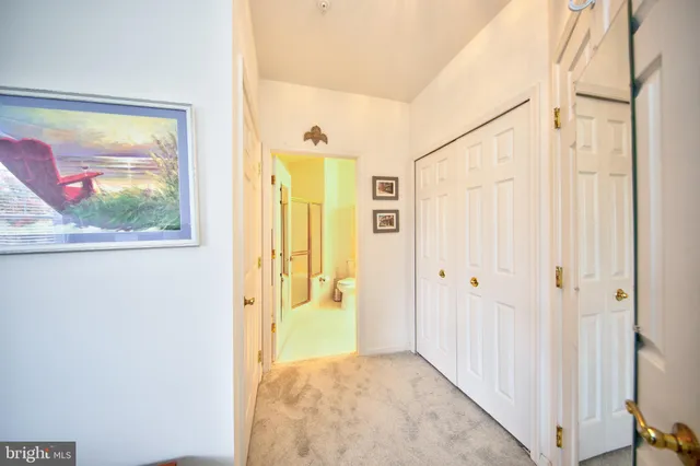 a view of a hallway with wooden floor and door