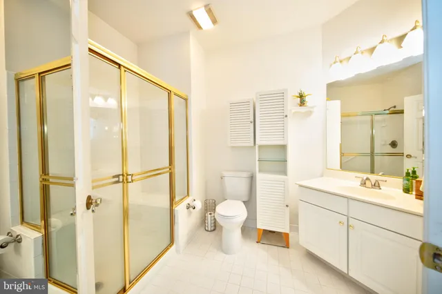 a bathroom with a double vanity sink toilet and shower