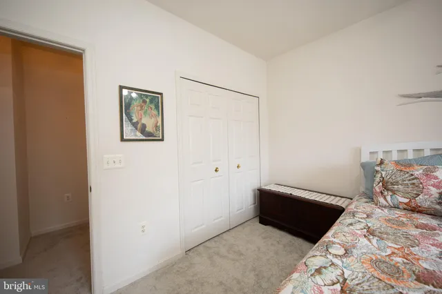 a bed room with a bed and a painting on the wall