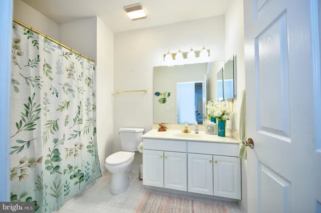 a spacious bathroom with a double vanity sink mirror and toilet